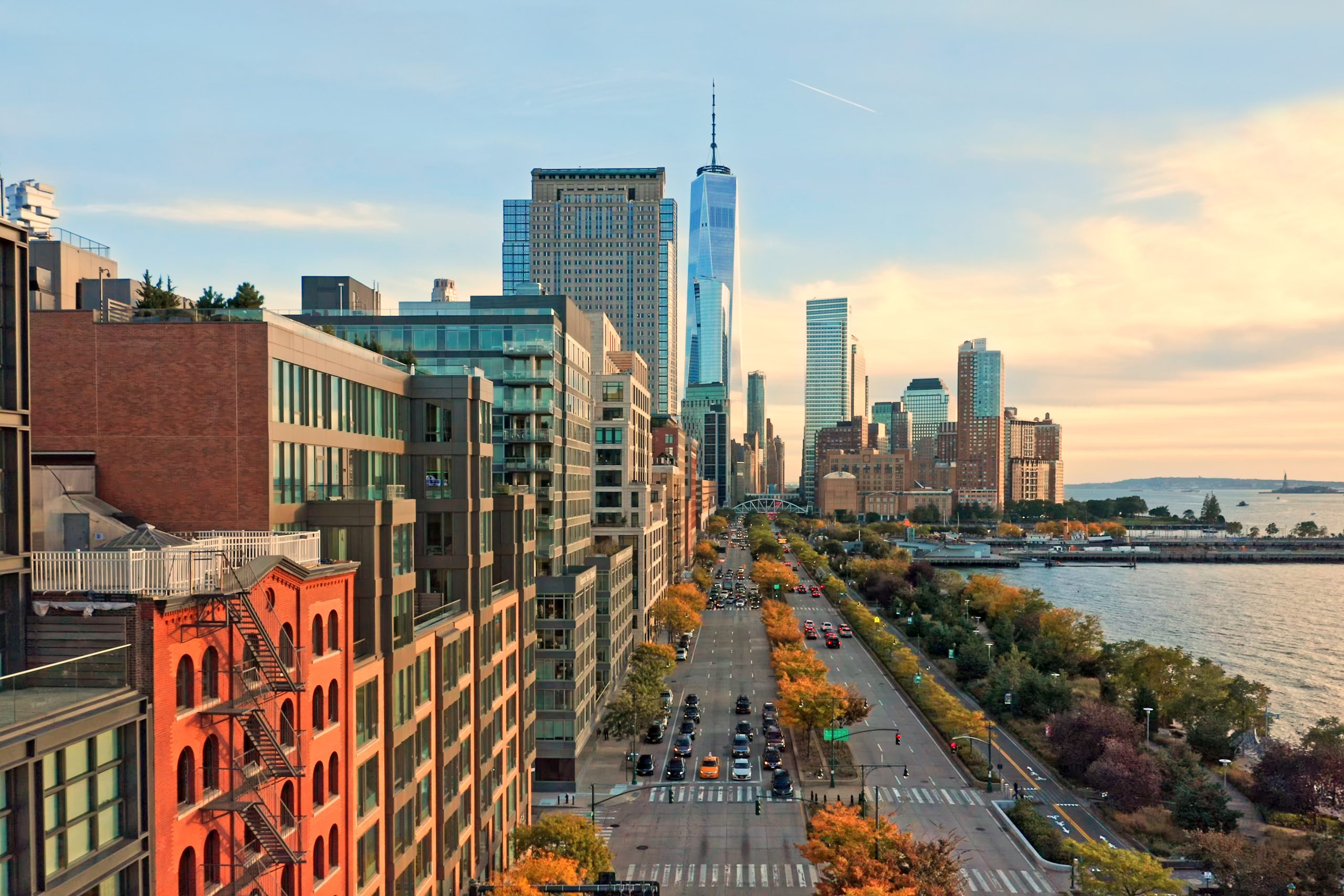 Aerial view of the Lower Manhattan skyline at sunset, viewed from above West Street in Tribeca.