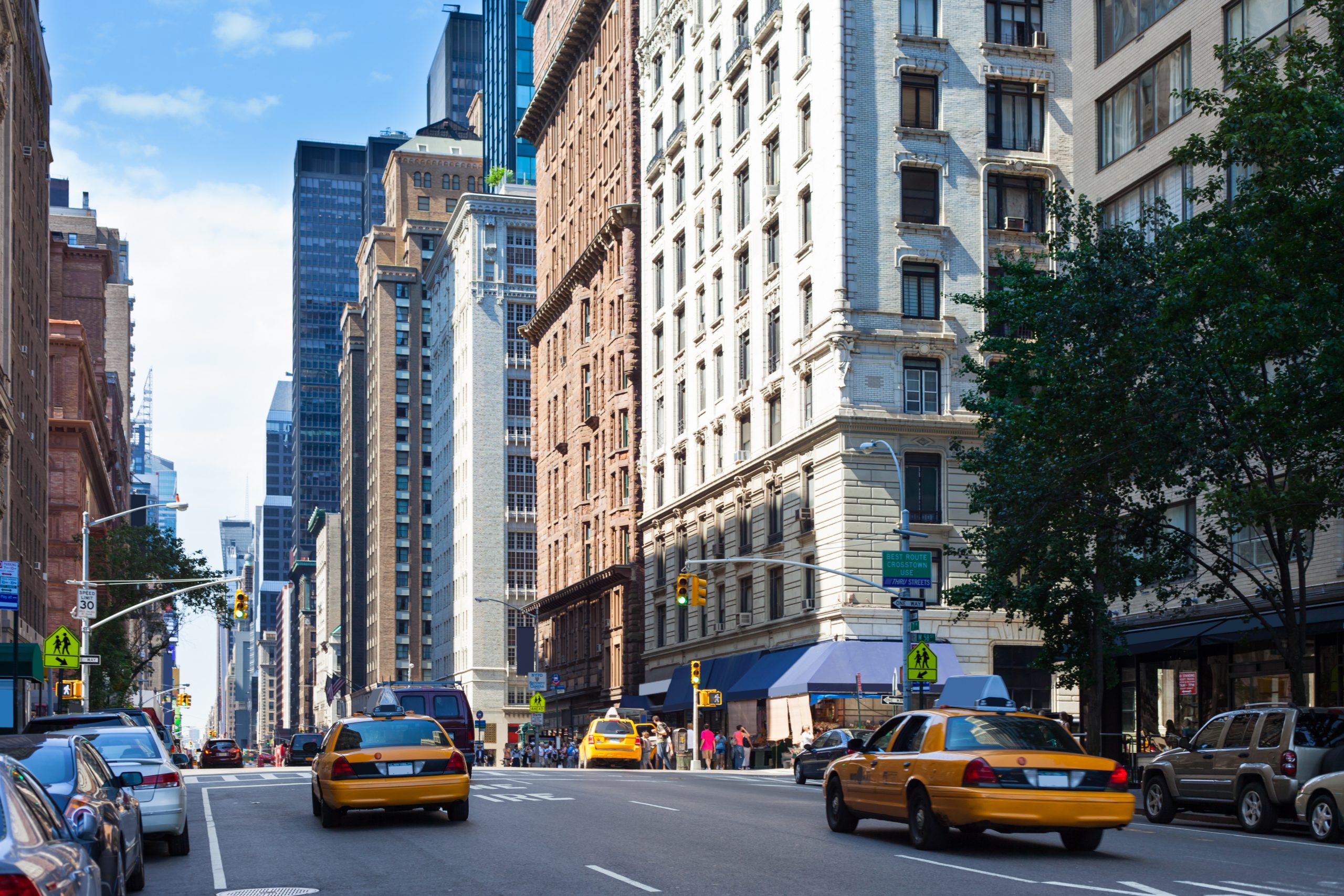 NYC street scene with skyscrapers, reflecting factors influencing Manhattan office space prices.