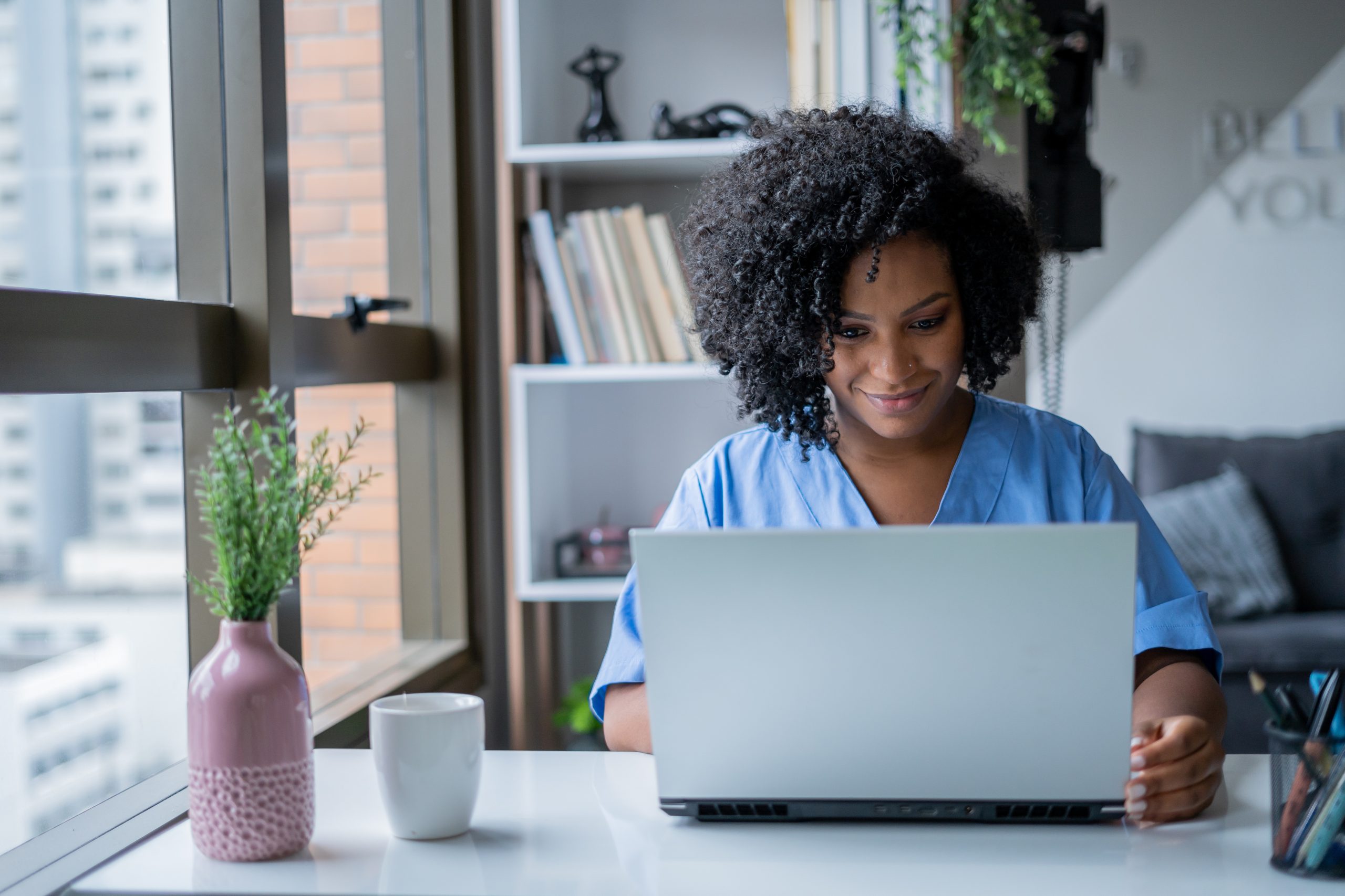 Nurse conducts a video call consultation in medical office space in Manhattan.