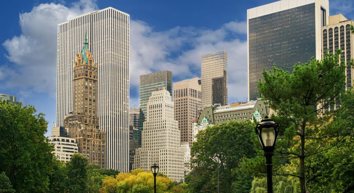 Midtown Manhattan skyline from Central Park with trees and lamppost