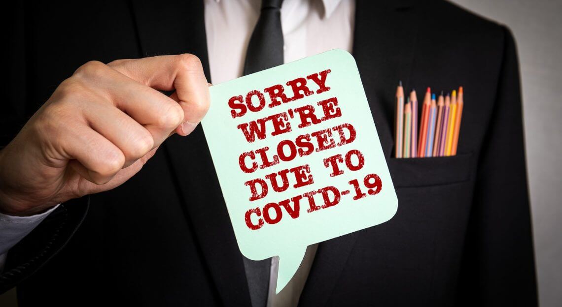 A person in a suit holds a 