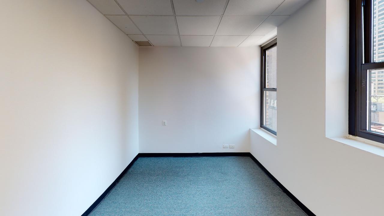 353 Lexington Avenue Office rental, empty private office with white walls, blue carpe.