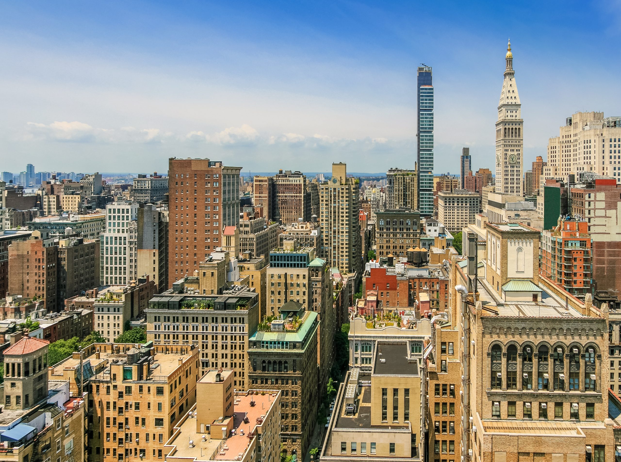 Panoramic view of a Midtown Manhattan skyline with historic and modern buildings.
