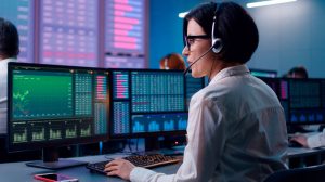 Young woman trading stocks in office