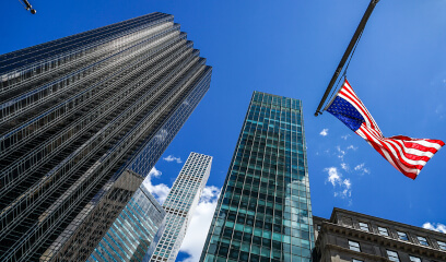 Trump Tower With The American Flag, Symbolizing Legal Turmoil In Nyc Commercial Real Estate.