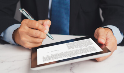 Businessman signs digital lease contract in NYC office space.