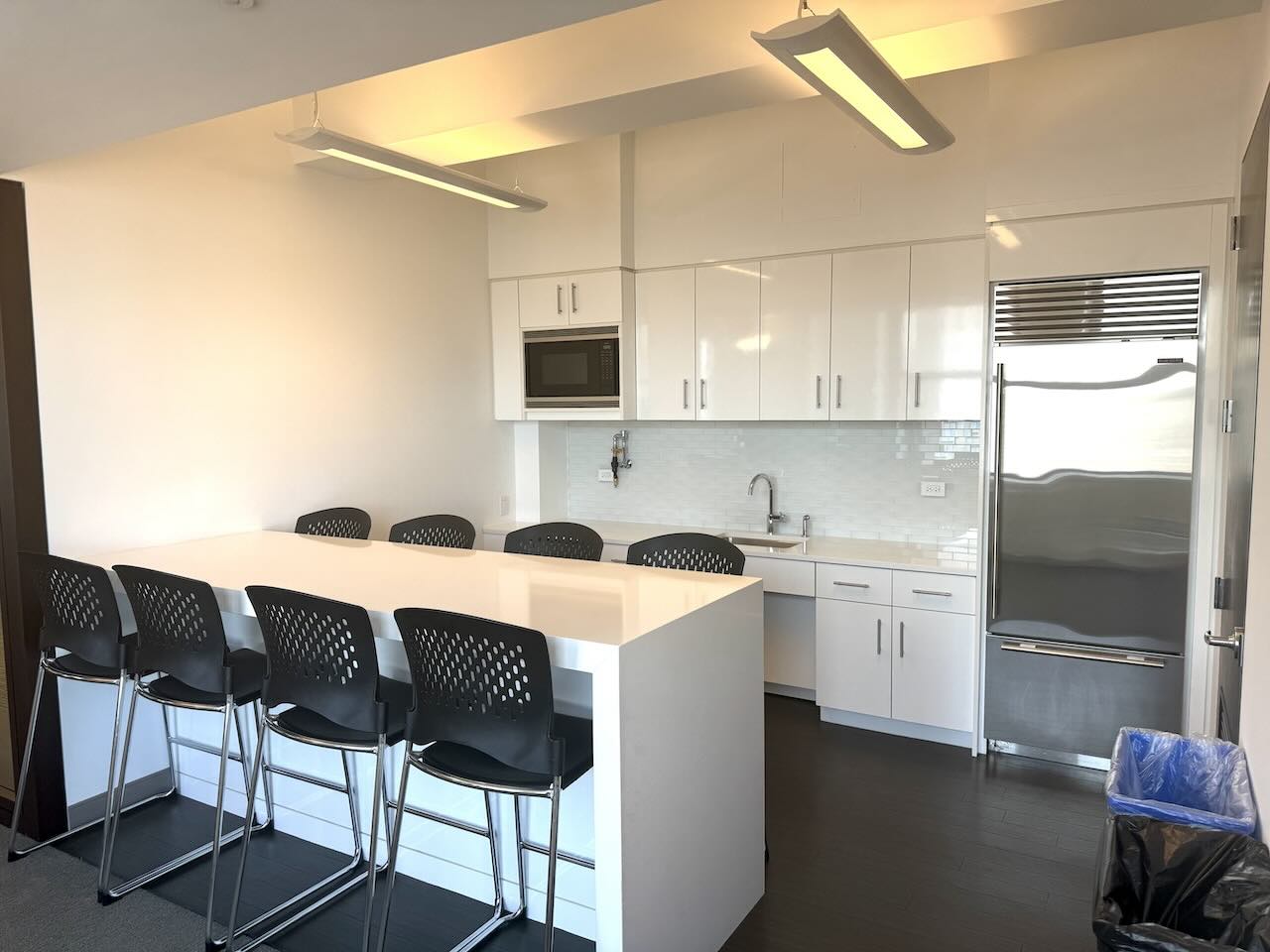 Address, Office Space, Suite Number: 12345 Example St, Office Space, Suite 678
ALT Tag: Modern kitchen with white island countertop, black chairs, white cabinets and stainless steel appliances.