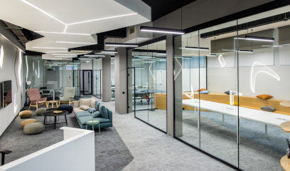 Empty office leisure area with modern lighting and a glass conference room.