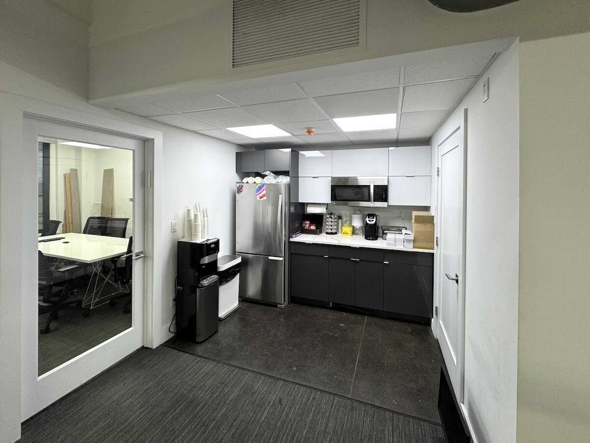 Small office kitchen with black and white decor on East 44th Street.