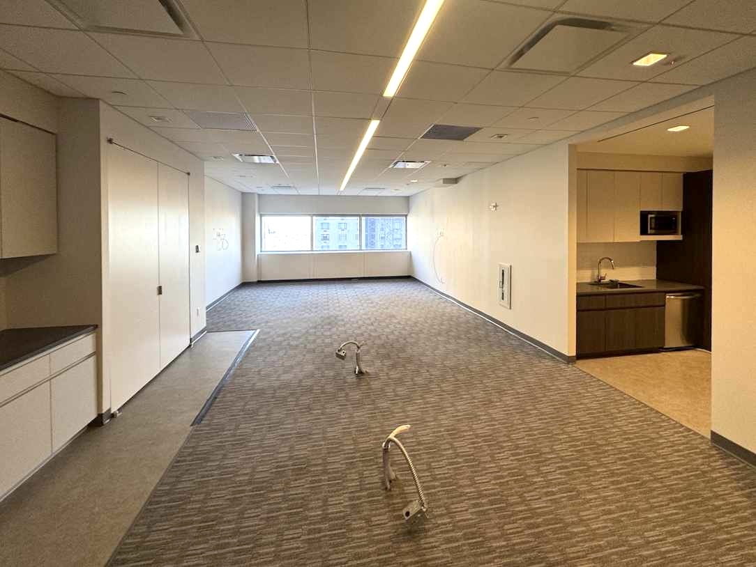 20th floor office with beige interior, kitchenette, and city views.