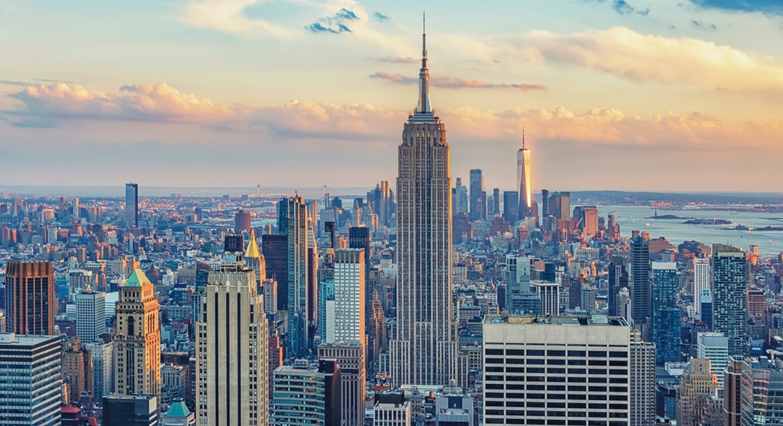 Aerial view of NYC skyline at sunset with Empire State Building.
