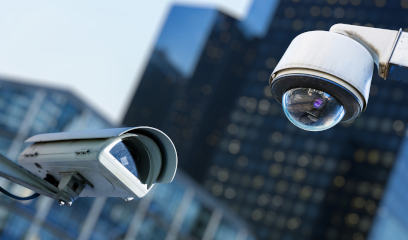 Security cameras mounted outdoors with NYC buildings behind.