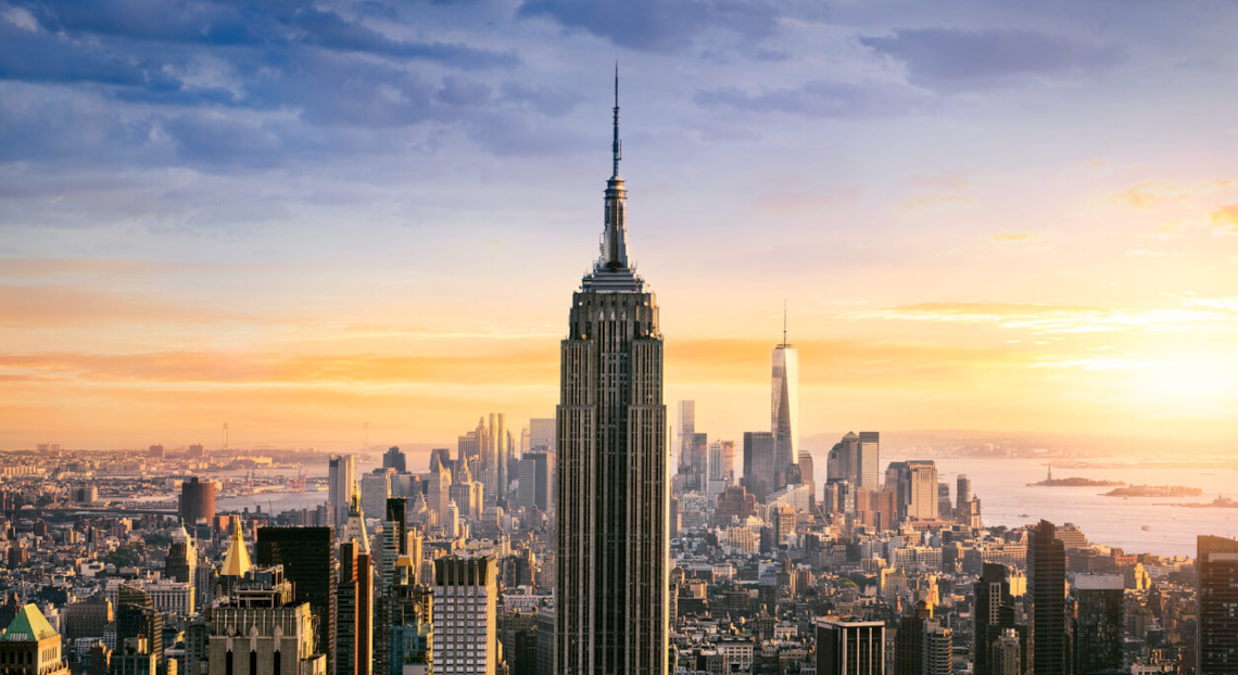 Empire State Building and cityscape at sunset, One World Trade visible