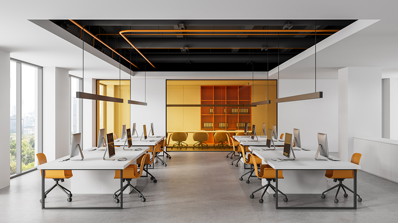 Open NYC office with white desks, orange chairs, and glass meeting room.